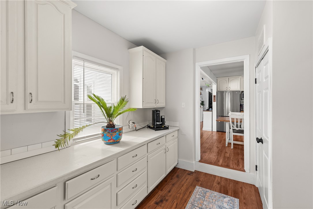 8767 Edgehill Road Mentor, OH 44060 - Photo 5 of 47 Kitchen featuring stainless steel refrigerator, white cabinetry, and dark hardwood / wood-style flooring