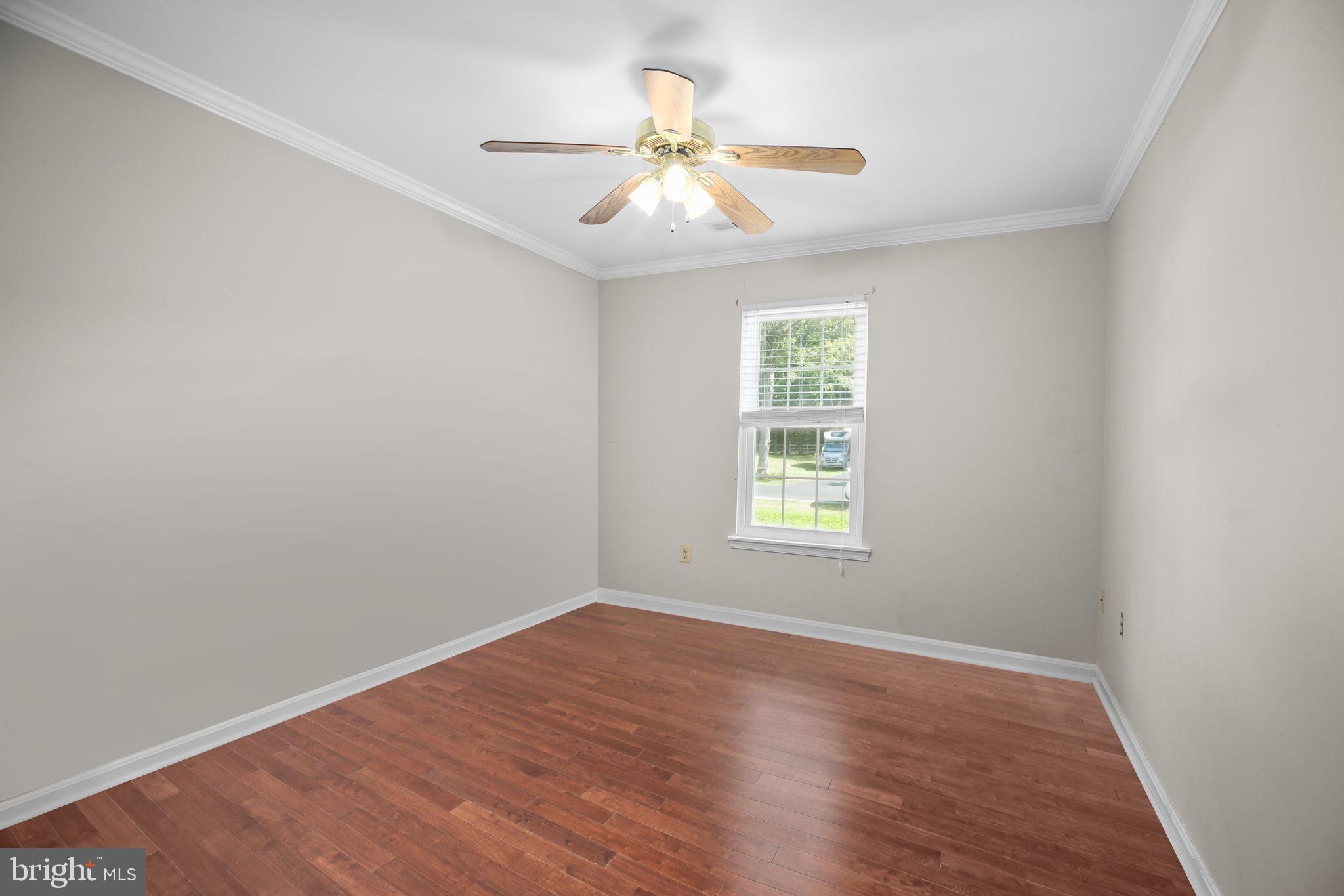 5705 Cascade Drive Fredericksburg, VA 22407 - Photo 25 of 32 an empty room with wooden floor chandelier fan and windows