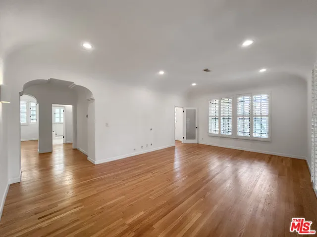 a view of a room with wooden floor and window