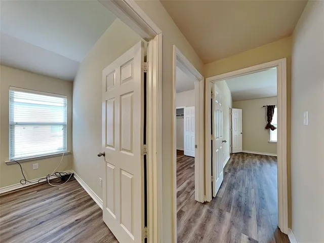 a view of a room with wooden floor and a bathroom