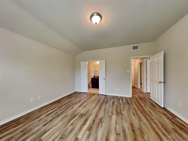a view of a room with wooden floor