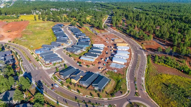 an aerial view of residential houses with outdoor space and river