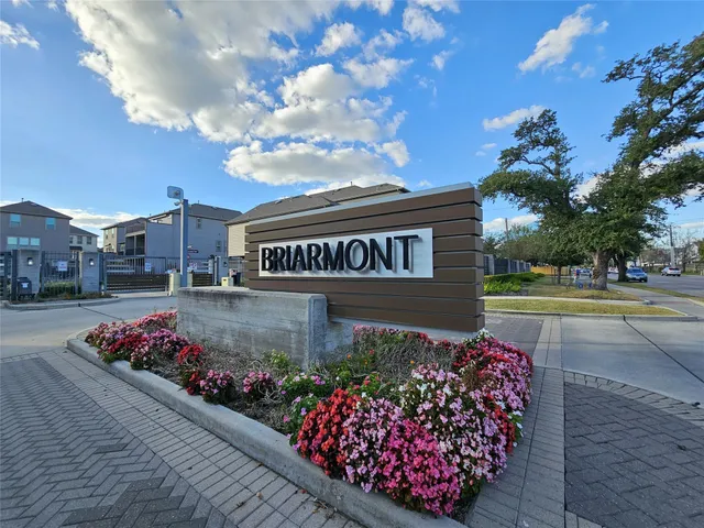 a view of a street with flowers