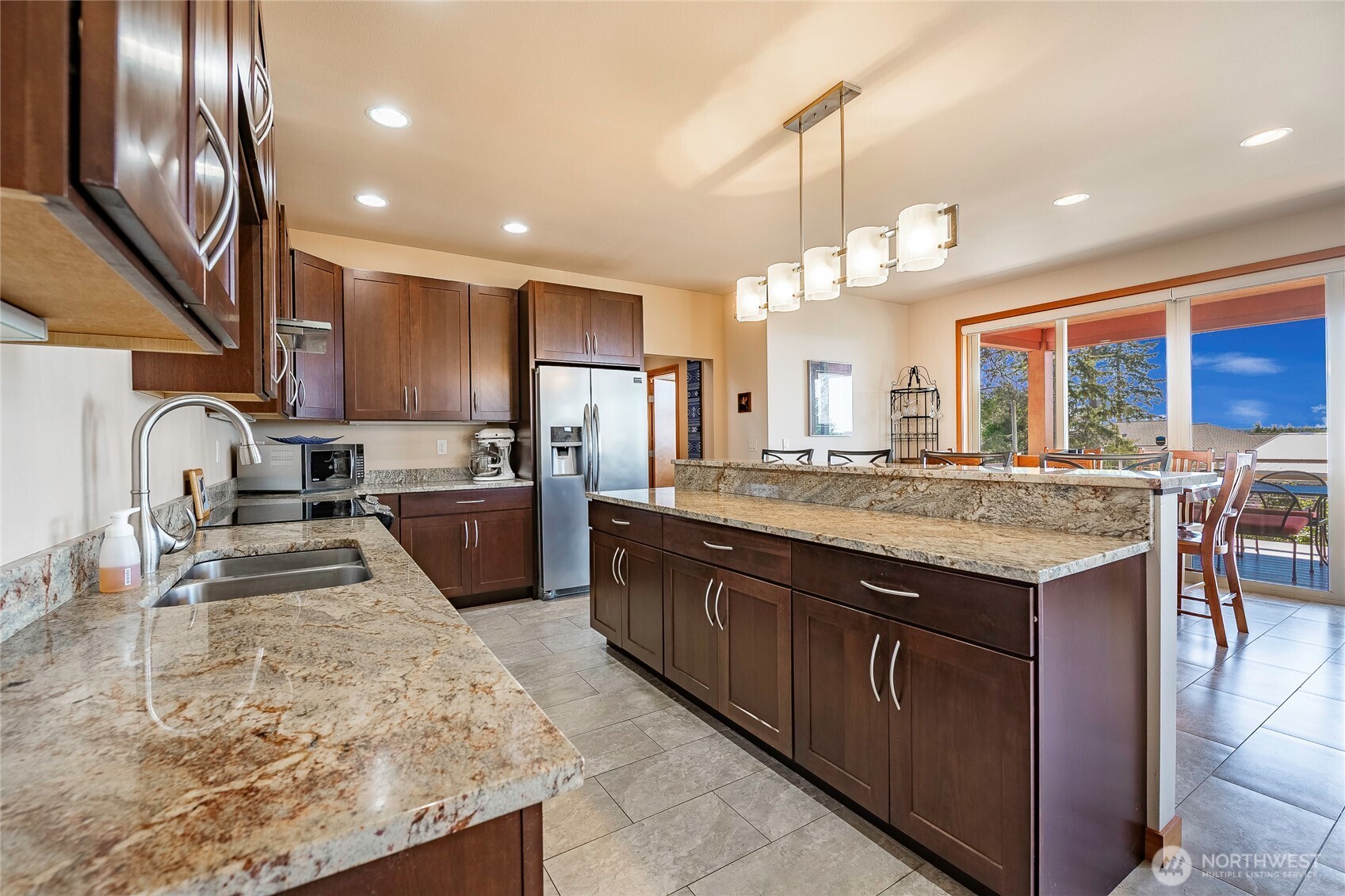 8285 Sunset Street Blaine, WA 98230 - Photo 17 of 38 a kitchen with stainless steel appliances granite countertop a sink a stove and a refrigerator