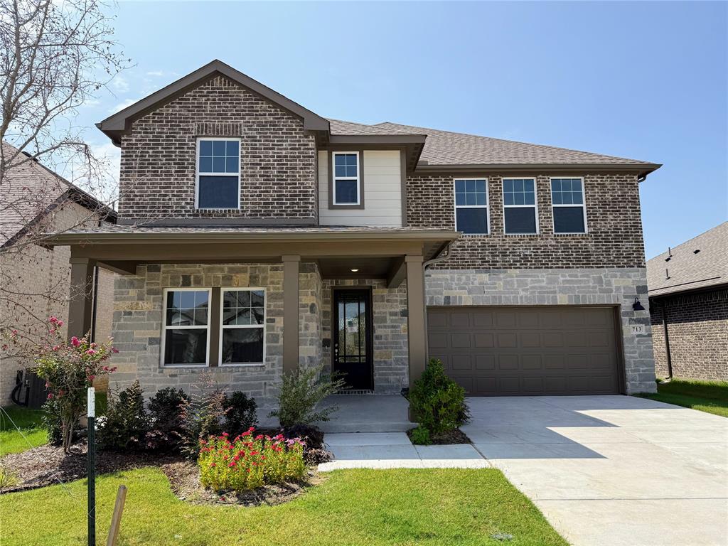713 Roanoke Drive Princeton, TX 75407 - Photo 1 of 40 View of front of property with a porch, a garage, concrete driveway, stone siding, and a front lawn