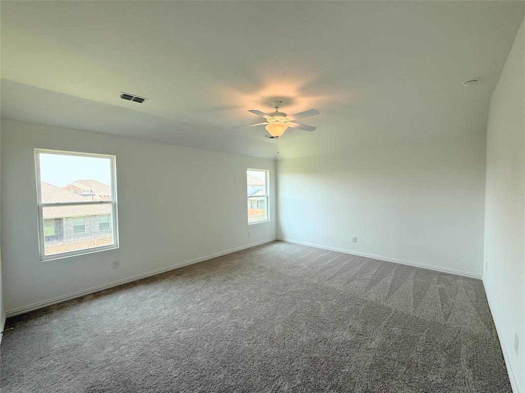 713 Roanoke Drive Princeton, TX 75407 - Photo 12 of 40 Spare room with light colored carpet and ceiling fan