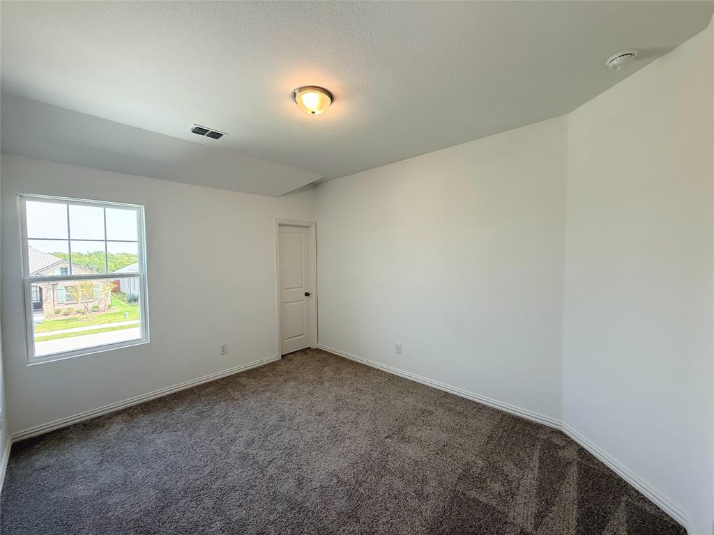 713 Roanoke Drive Princeton, TX 75407 - Photo 23 of 40 Empty room featuring carpet floors and baseboards