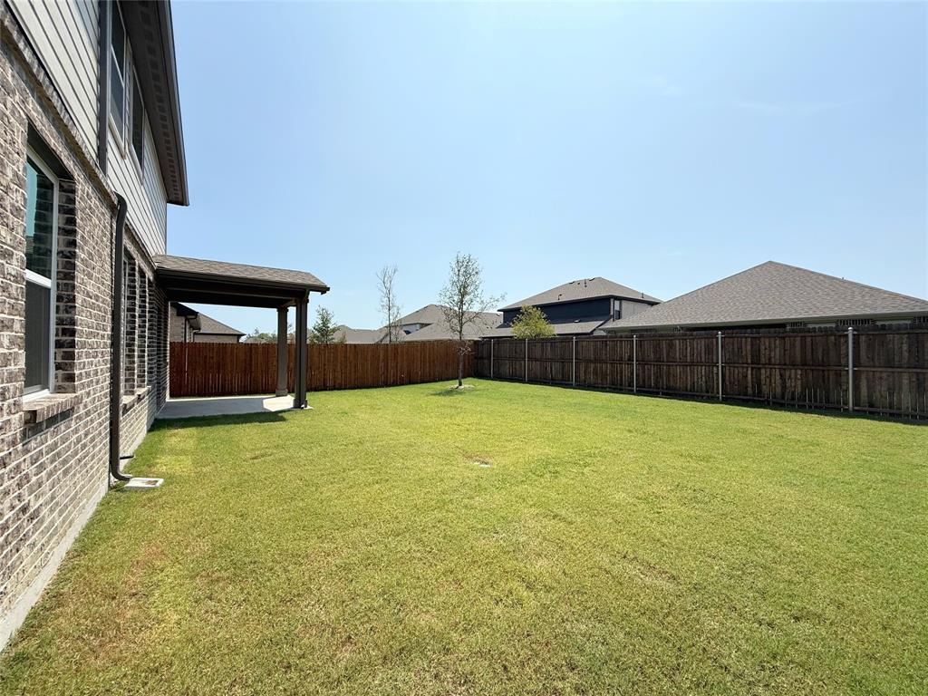 713 Roanoke Drive Princeton, TX 75407 - Photo 31 of 40 Fenced backyard featuring a patio area