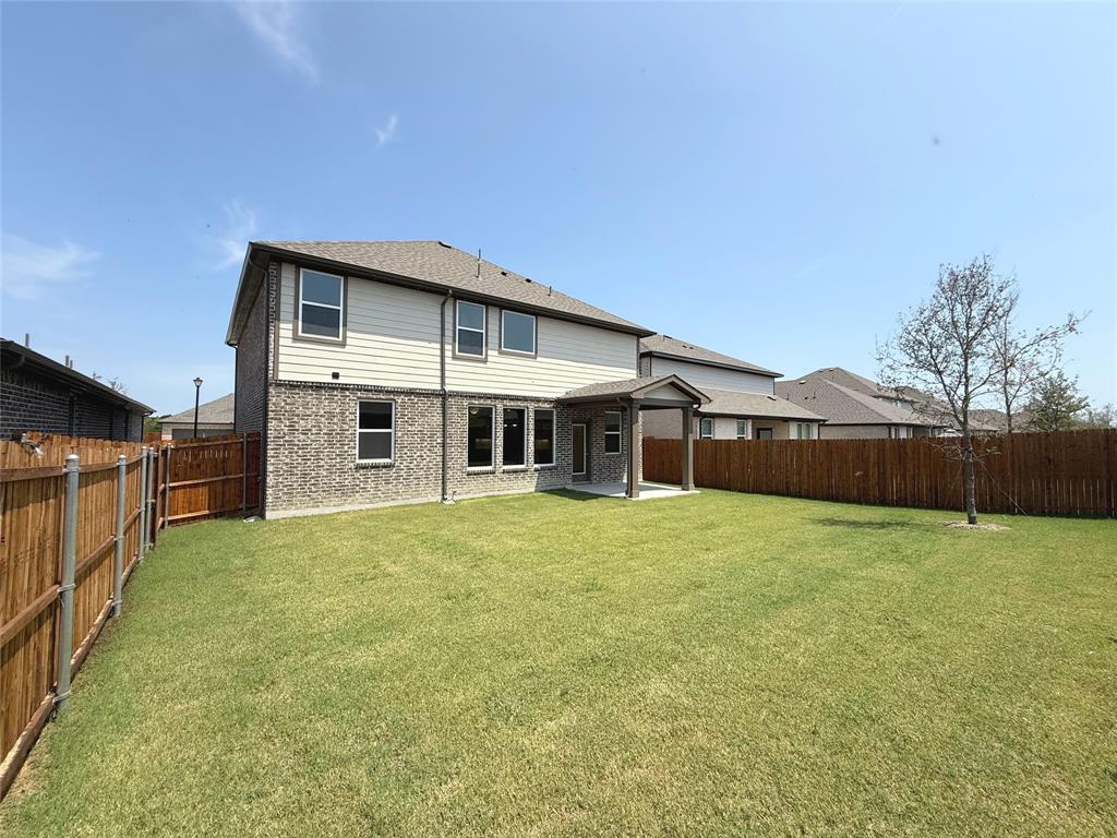713 Roanoke Drive Princeton, TX 75407 - Photo 32 of 40 Rear view of property with a patio area, brick siding, and a fenced backyard