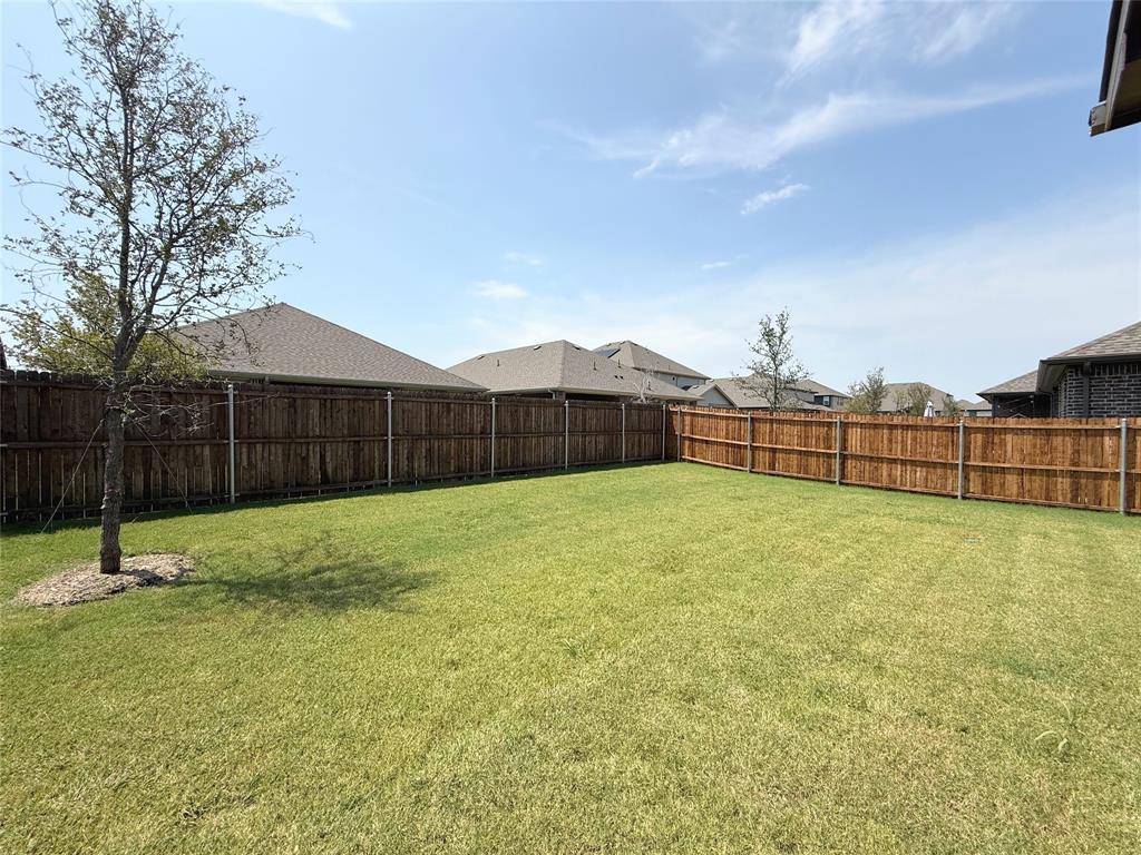 713 Roanoke Drive Princeton, TX 75407 - Photo 35 of 40 Fenced backyard with a residential view