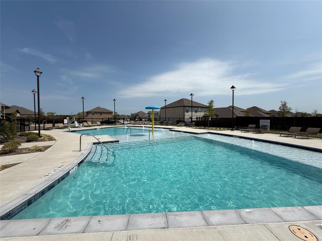 713 Roanoke Drive Princeton, TX 75407 - Photo 37 of 40 Community pool featuring a residential view and a patio area