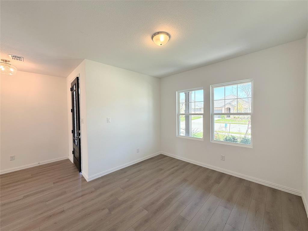 713 Roanoke Drive Princeton, TX 75407 - Photo 6 of 40 Unfurnished room with baseboards and light wood-style flooring
