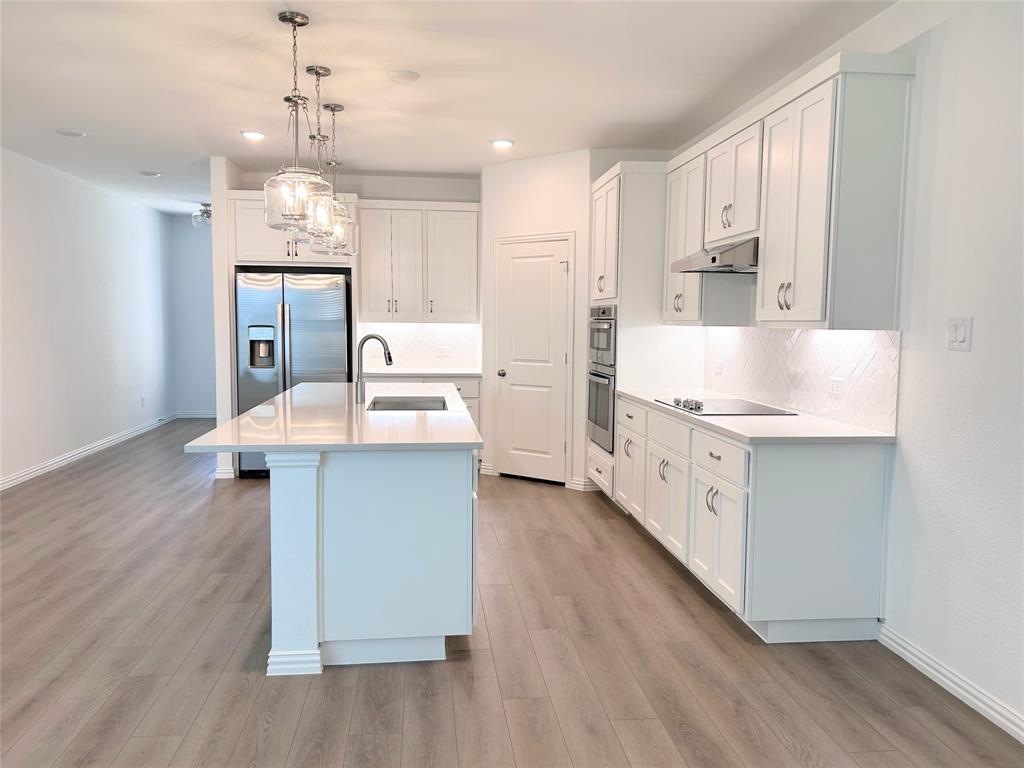 713 Roanoke Drive Princeton, TX 75407 - Photo 9 of 40 Kitchen with white cabinetry, decorative light fixtures, tasteful backsplash, and recessed lighting