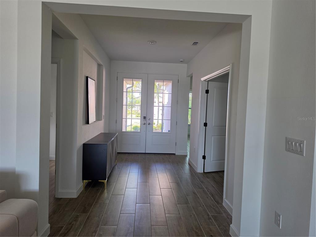 18334 Ridgeline Drive Estero, FL 33928 - Photo 13 of 30 a view of hallway with furniture and wooden floor