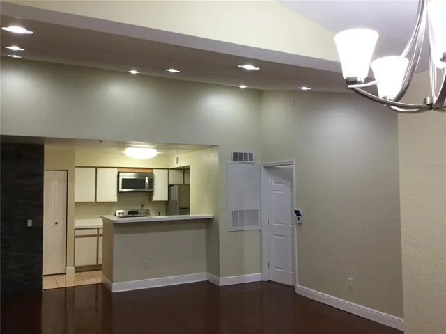 a view of a kitchen center island and stainless steel appliances