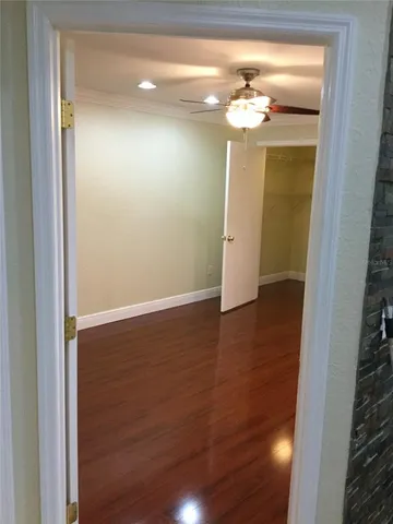 a view of a chandelier in big room with wooden floor