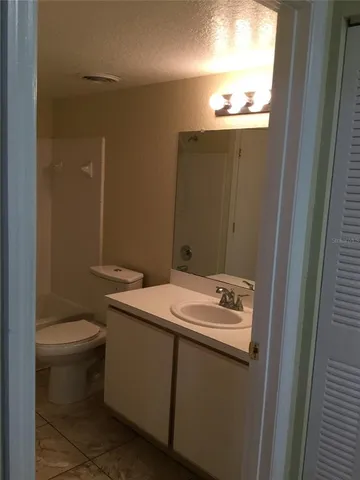 a bathroom with a sink toilet and window
