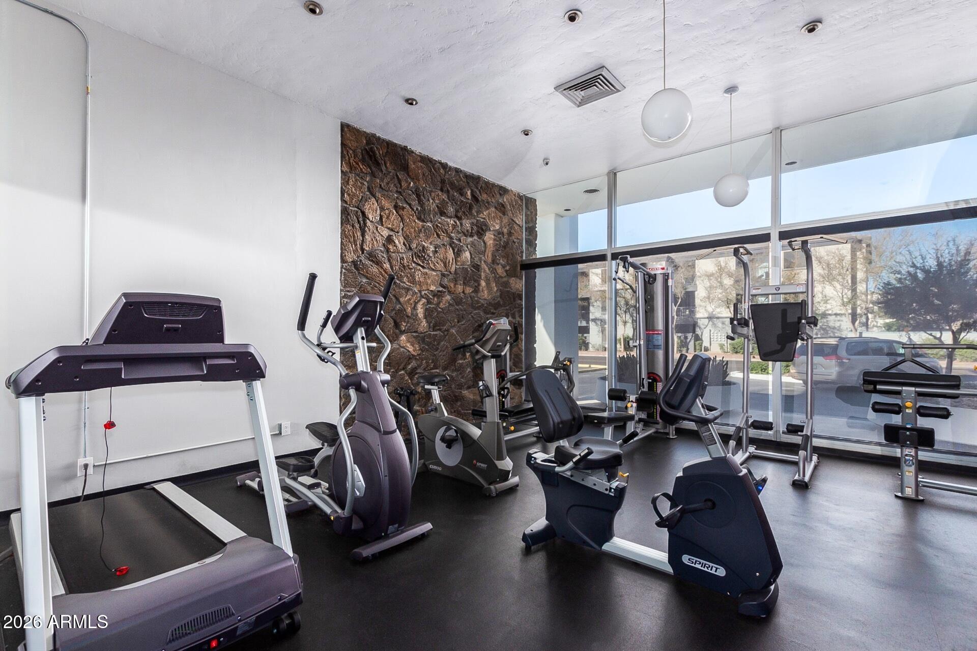 207 West Clarendon Avenue, Unit B2 Phoenix, AZ 85013 - Photo 26 of 30 a room with gym equipment and a large window