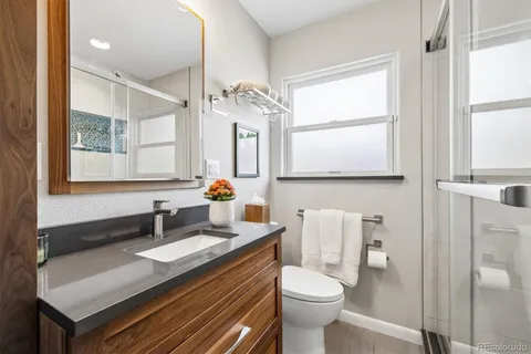 a bathroom with a sink toilet and shower