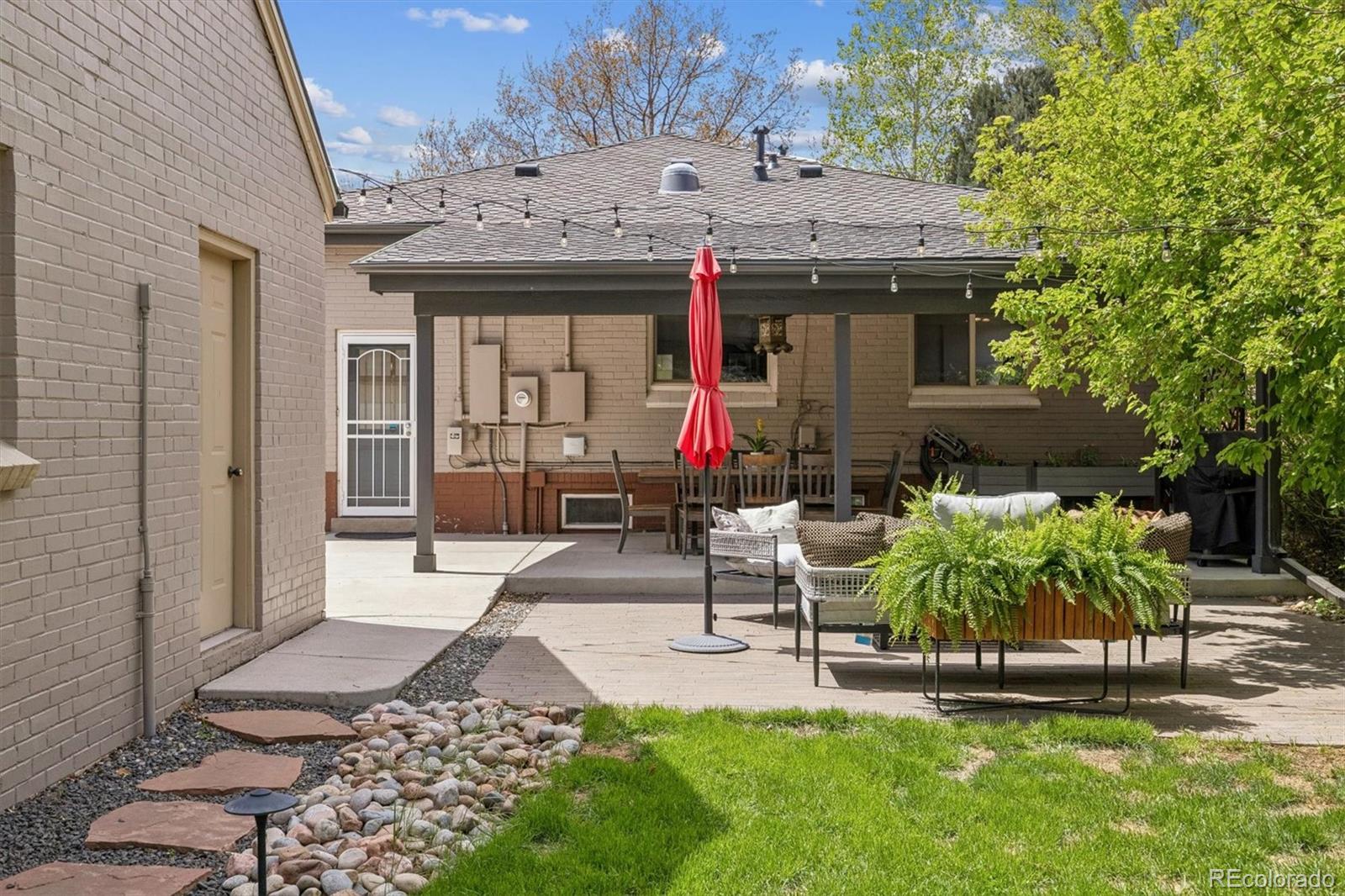730 Ivanhoe Street Denver, CO 80220 - Photo 34 of 34 a view of a patio with table and chairs potted plants and large tree