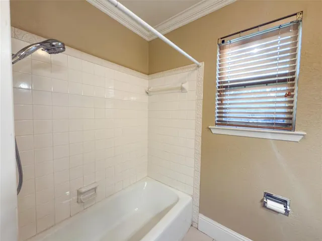 a bathroom with a bathtub and shower