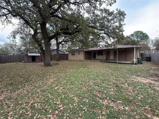 a front view of house with yard and trees