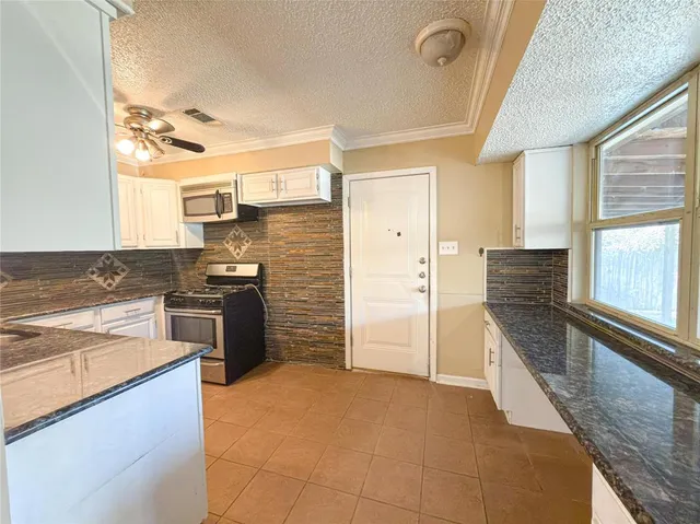 a kitchen with a refrigerator and a sink
