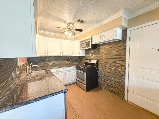 a kitchen with stainless steel appliances granite countertop a sink and cabinets