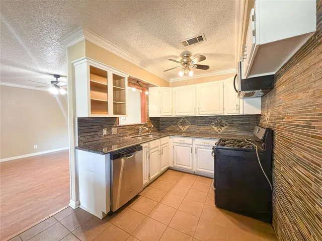 a kitchen with stainless steel appliances granite countertop a stove and a sink