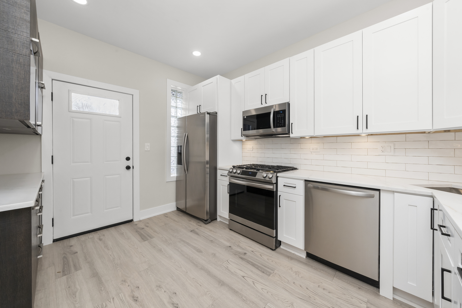 3107 West Flournoy Street Chicago, IL 60612 - Photo 20 of 39 a kitchen with stainless steel appliances a refrigerator stove and microwave