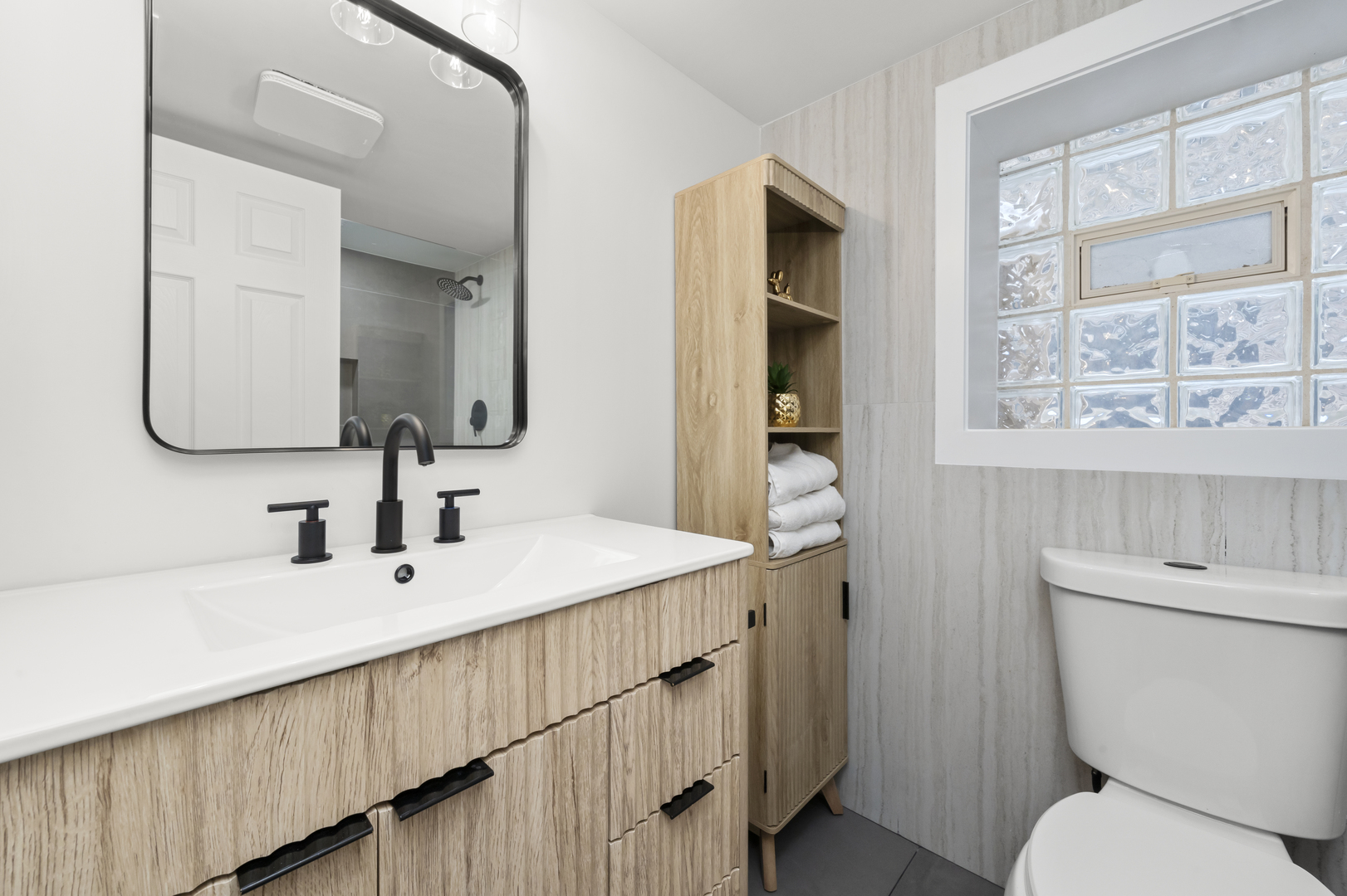 3107 West Flournoy Street Chicago, IL 60612 - Photo 30 of 39 a bathroom with a double vanity sink toilet and a mirror
