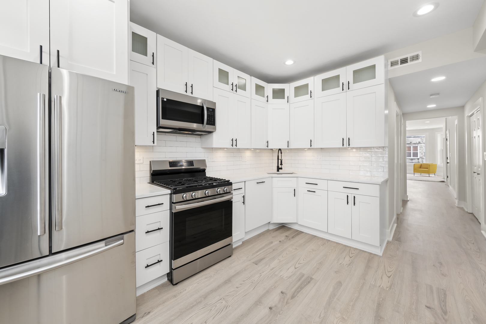 3107 West Flournoy Street Chicago, IL 60612 - Photo 7 of 39 a kitchen with stainless steel appliances granite countertop a stove a sink and a refrigerator