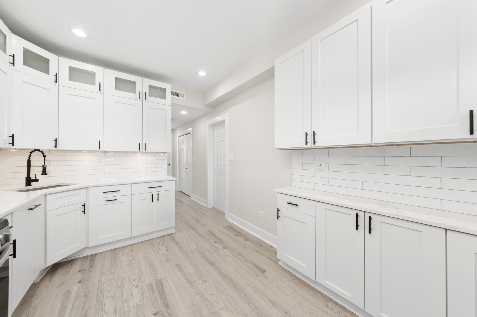 3107 West Flournoy Street Chicago, IL 60612 - Photo 8 of 39 a view of a kitchen with sink and dishwasher with wooden floor
