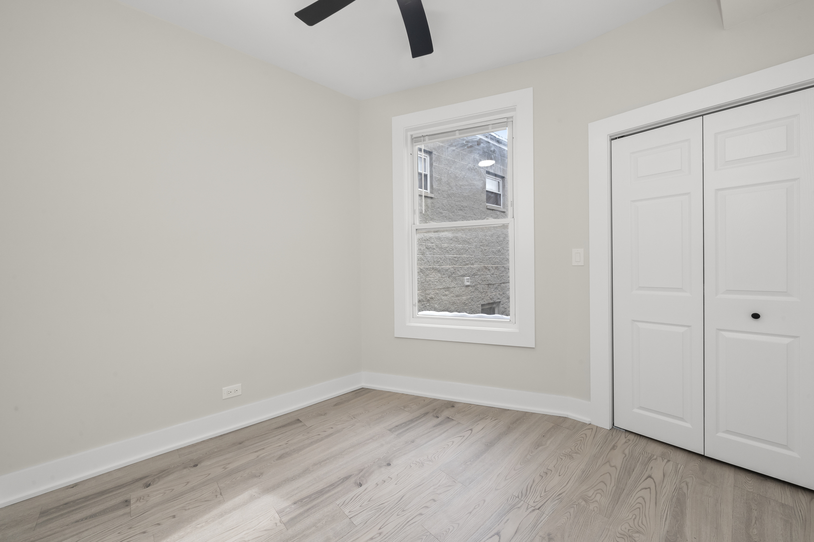 3107 West Flournoy Street Chicago, IL 60612 - Photo 10 of 39 an empty room with wooden floor cabinet and windows