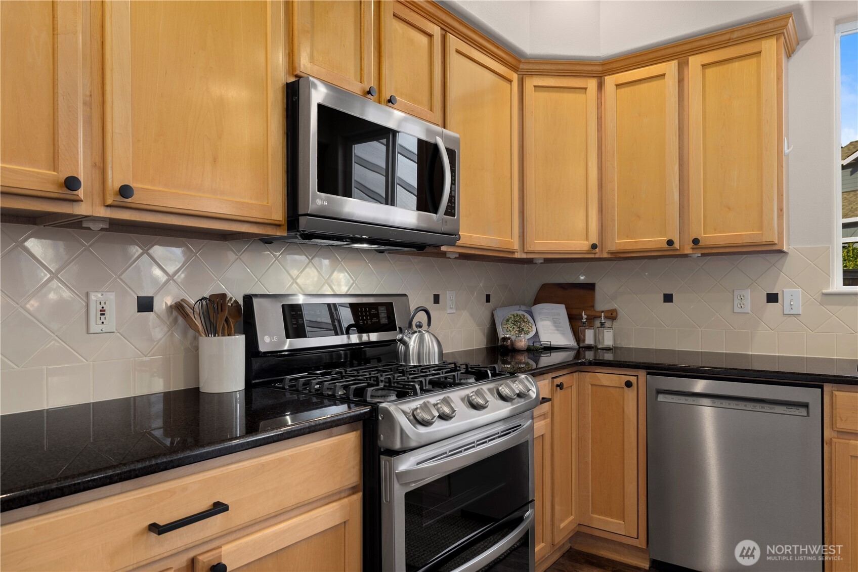 105 202nd Street Southeast Bothell, WA 98012 - Photo 17 of 40 a kitchen with stainless steel appliances granite countertop a sink a stove a microwave oven and cabinets