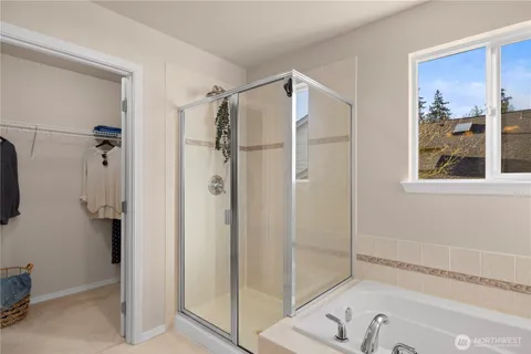 a bathroom with a bathtub and a shower
