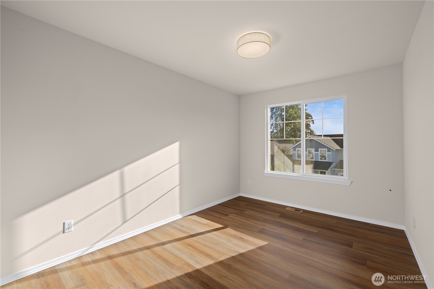 105 202nd Street Southeast Bothell, WA 98012 - Photo 33 of 40 a view of an empty room with wooden floor and a window