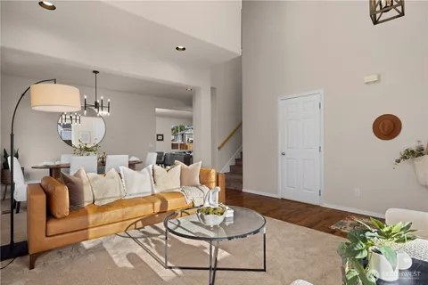 a living room with furniture potted plant and a mirror