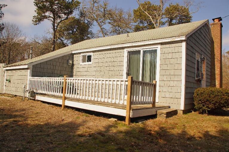 21 Gilbert Road Dennis Port, MA 02639 - Photo 4 of 18 a view of a house with a yard and fence