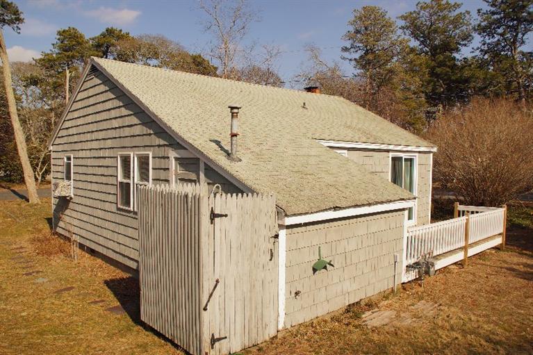 21 Gilbert Road Dennis Port, MA 02639 - Photo 5 of 18 a view of house with wooden stairs and a outdoor space
