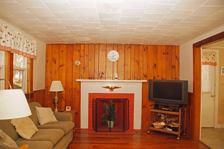 21 Gilbert Road Dennis Port, MA 02639 - Photo 7 of 18 a living room with furniture and a fireplace