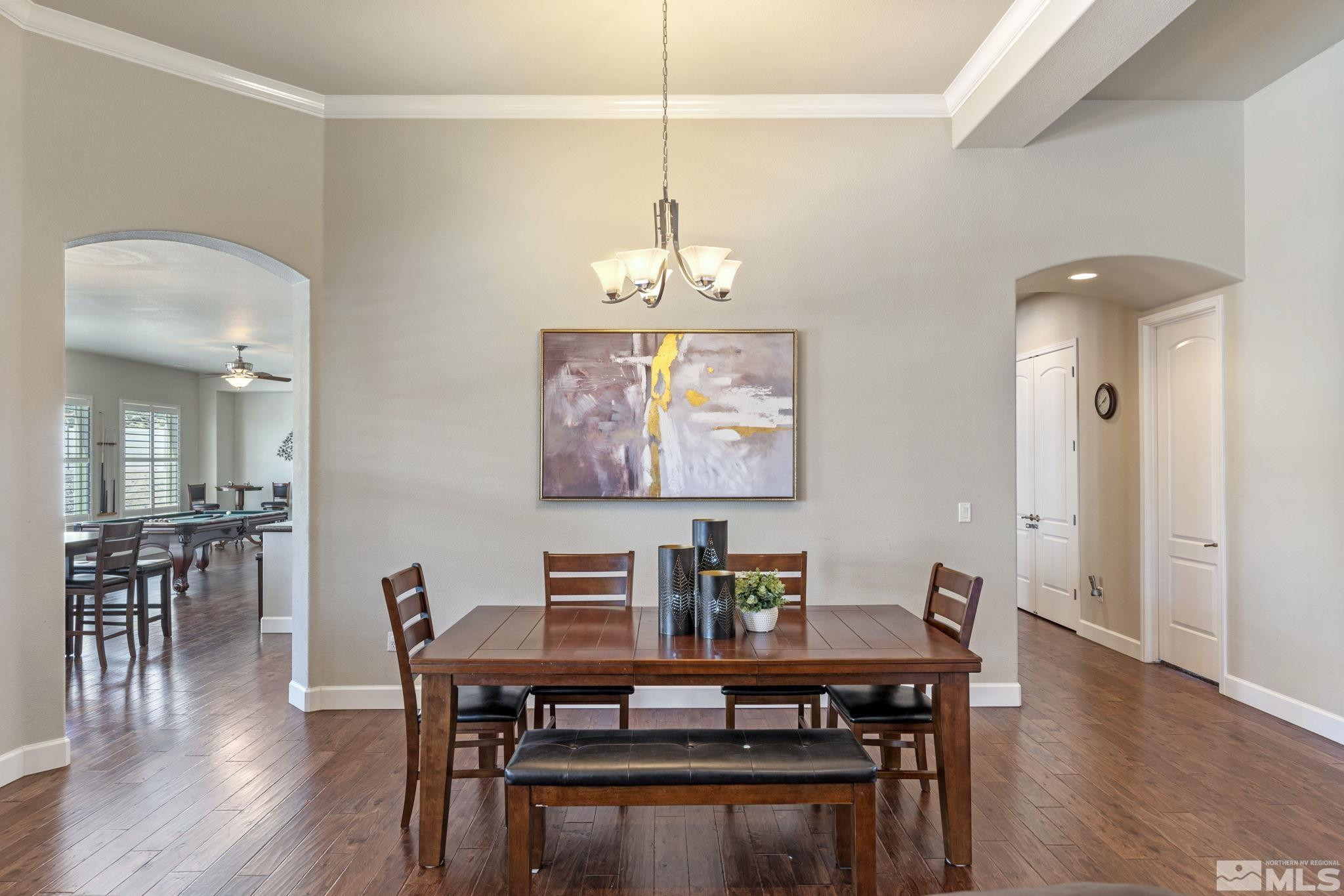 12265 Hidden Sparks, NV 89441 - Photo 12 of 39 a view of a dining room with furniture wooden floor and chandelier