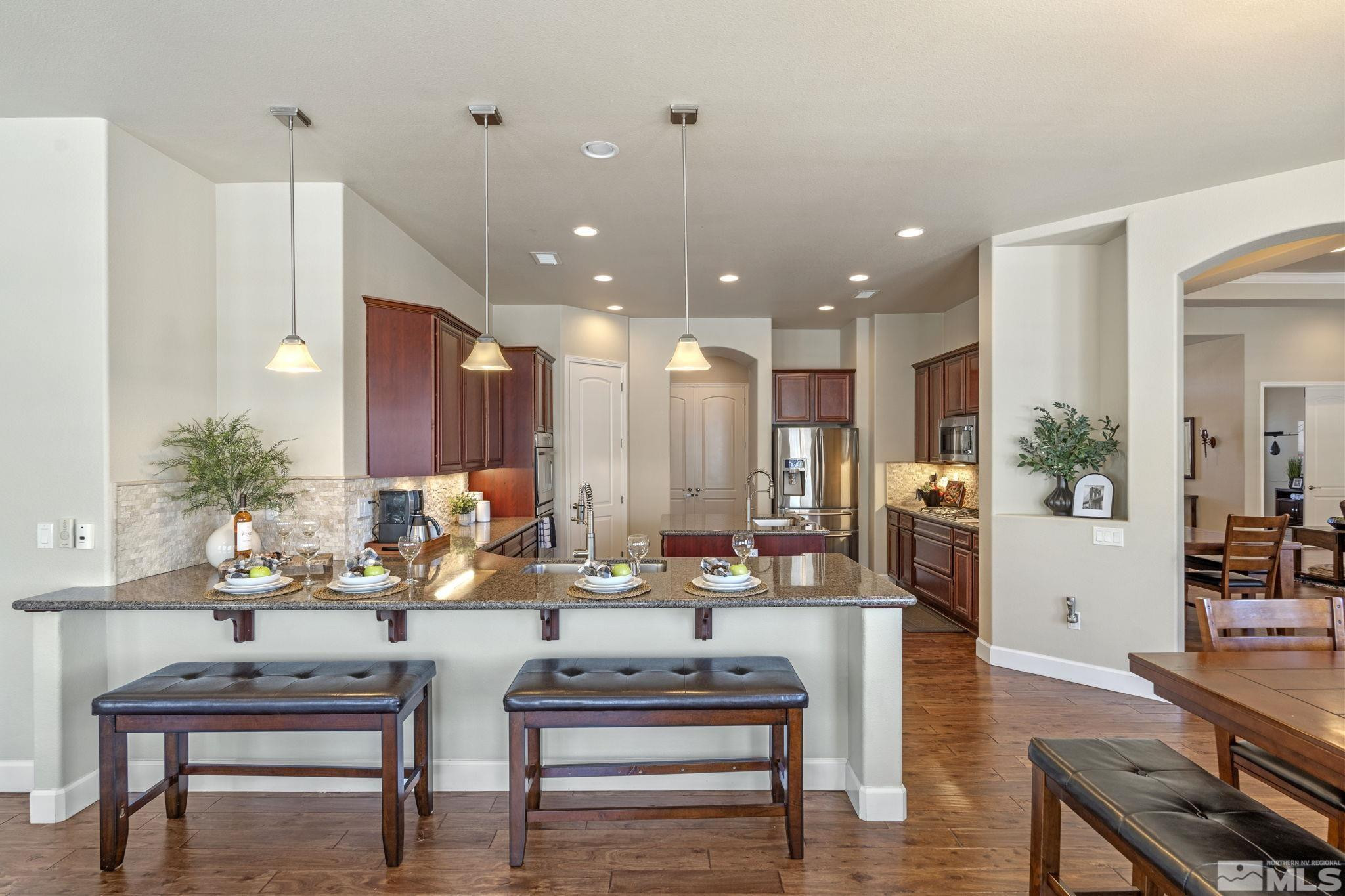 12265 Hidden Sparks, NV 89441 - Photo 13 of 39 a living room with furniture kitchen view and a potted plant