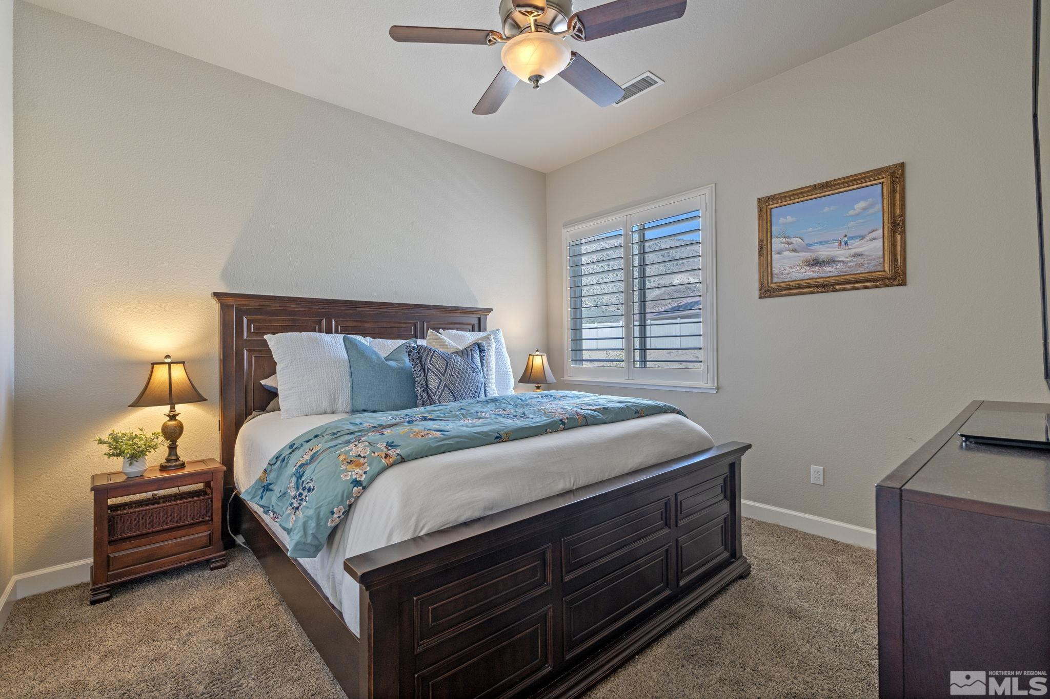 12265 Hidden Sparks, NV 89441 - Photo 26 of 39 a bedroom with a bed and a chandelier