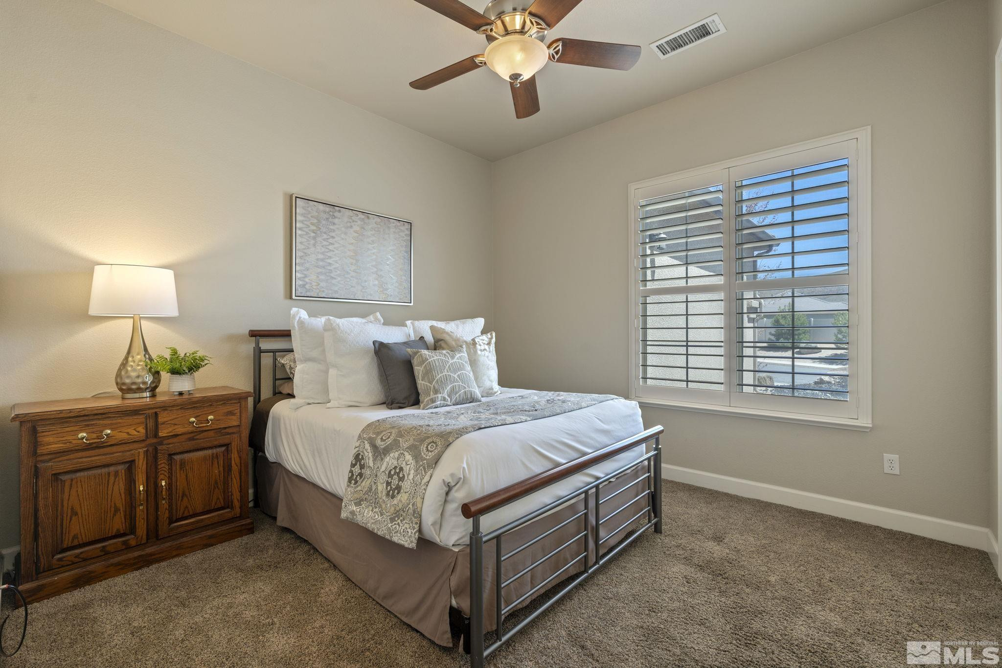 12265 Hidden Sparks, NV 89441 - Photo 27 of 39 a bed room with a bed and a chandelier
