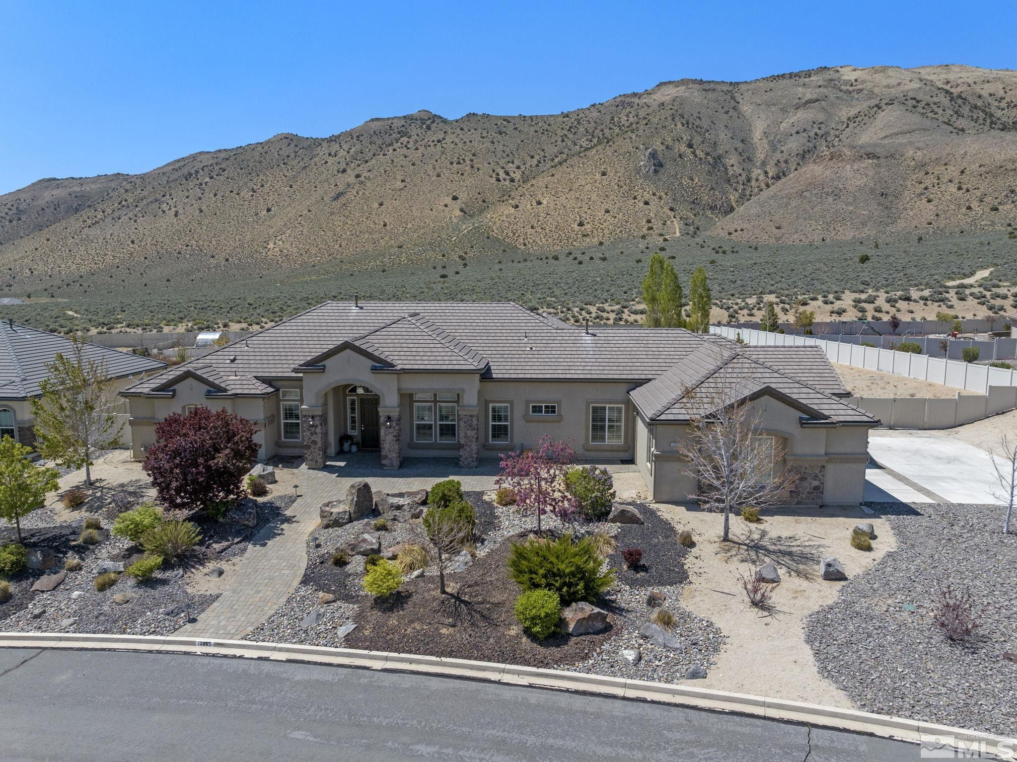 12265 Hidden Sparks, NV 89441 - Photo 8 of 39 an aerial view of a house with a yard and a large tree
