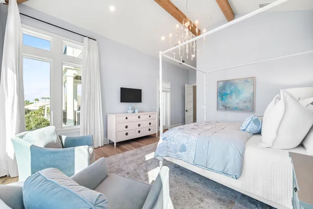 a view of a hallway with wooden floor and furniture