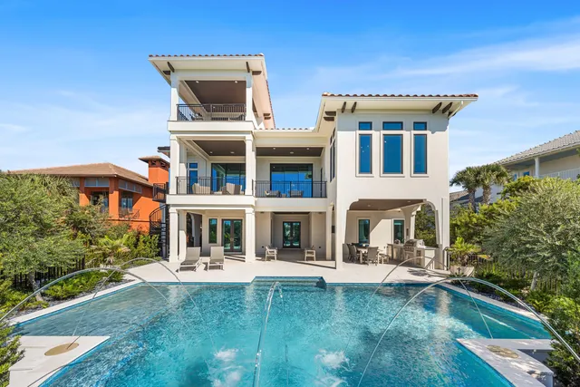 a kitchen with a table chairs sink and cabinets