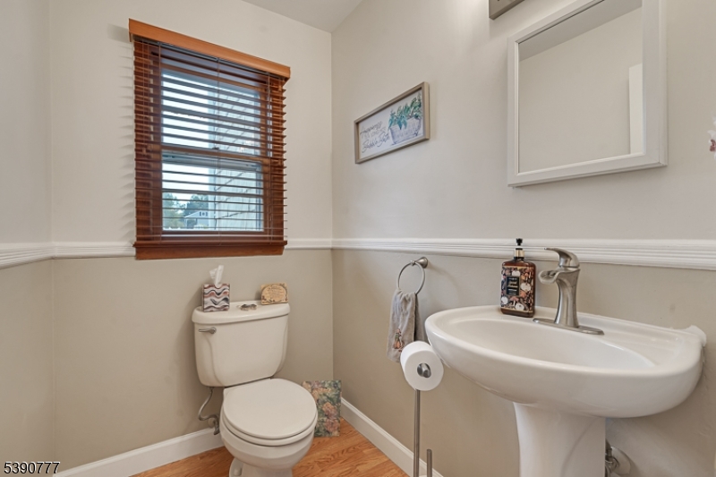 279 Madison Hill Road Clark, NJ 07066 - Photo 12 of 35 a bathroom with a sink a toilet and a mirror