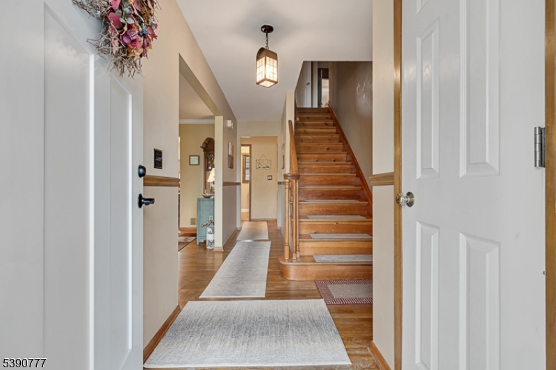 279 Madison Hill Road Clark, NJ 07066 - Photo 3 of 35 a view of hallway with stairs and wooden floor